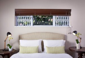 An image of Retractable Security Gates protecting bedroom windows.