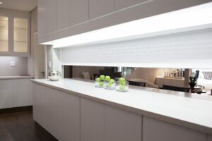 An image of roller shutters dividing the kitchen & living room.