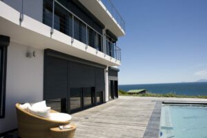 An image of roller shutters protecting a beach house.