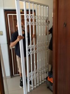 An image of Trellidor staff fitting a Security Gate.